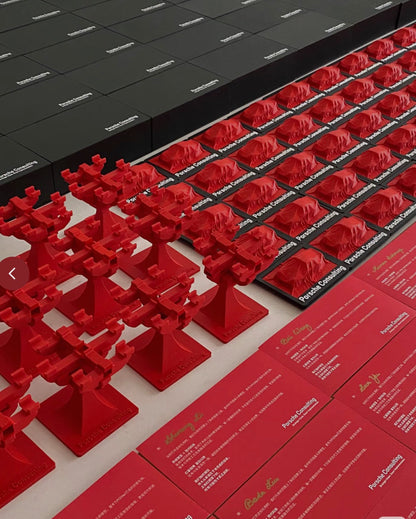 Empowering Brand Value: Premium 3D printed tree-shaped trophies and plaques by owl3dmesh for Porsche Consulting are showcased with branded boxes, exemplifying unique corporate gifts crafted for maximum brand impact.